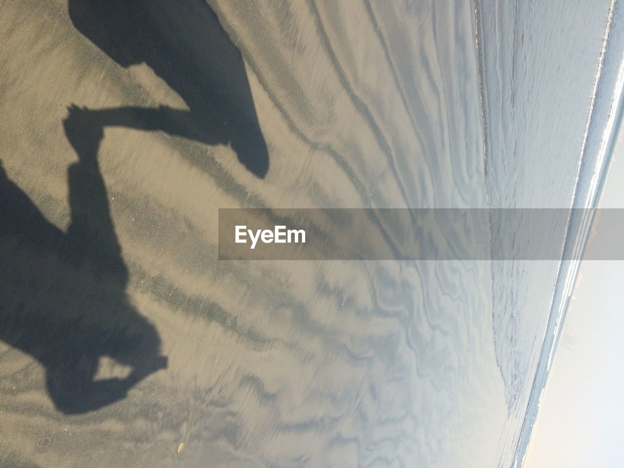 SHADOW ON SAND DUNE IN SKY