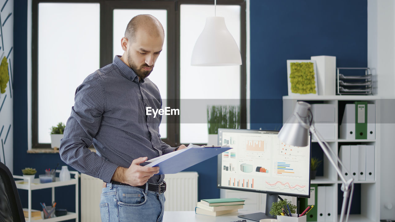 Businessman reviewing documents at office