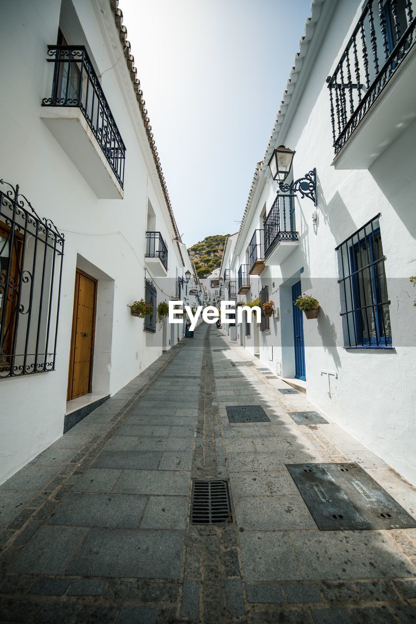 Empty alley amidst buildings in city