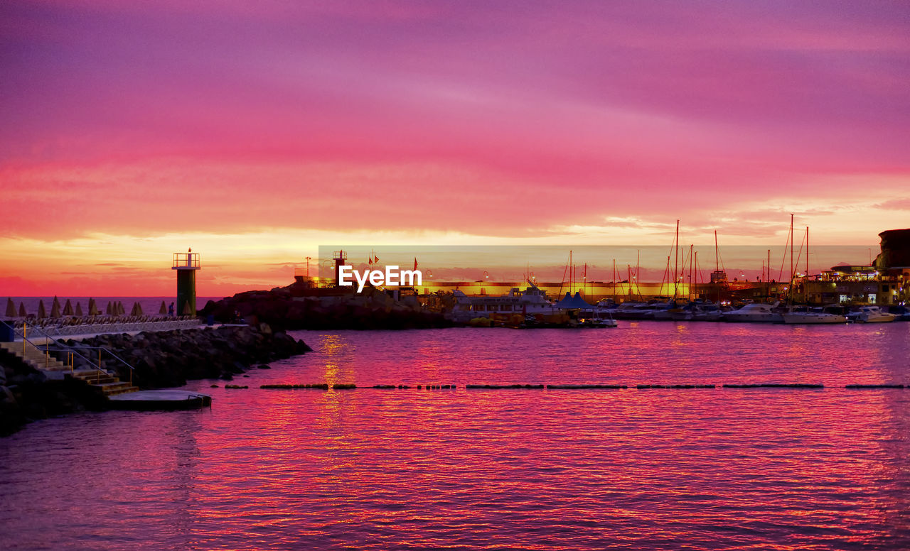 VIEW OF SEA AGAINST ORANGE SKY