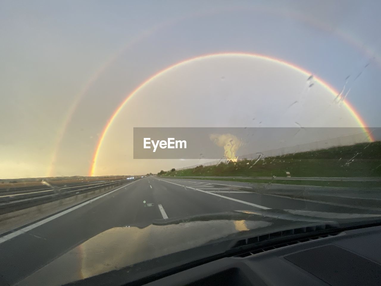 SCENIC VIEW OF RAINBOW AGAINST SKY SEEN THROUGH WINDSHIELD