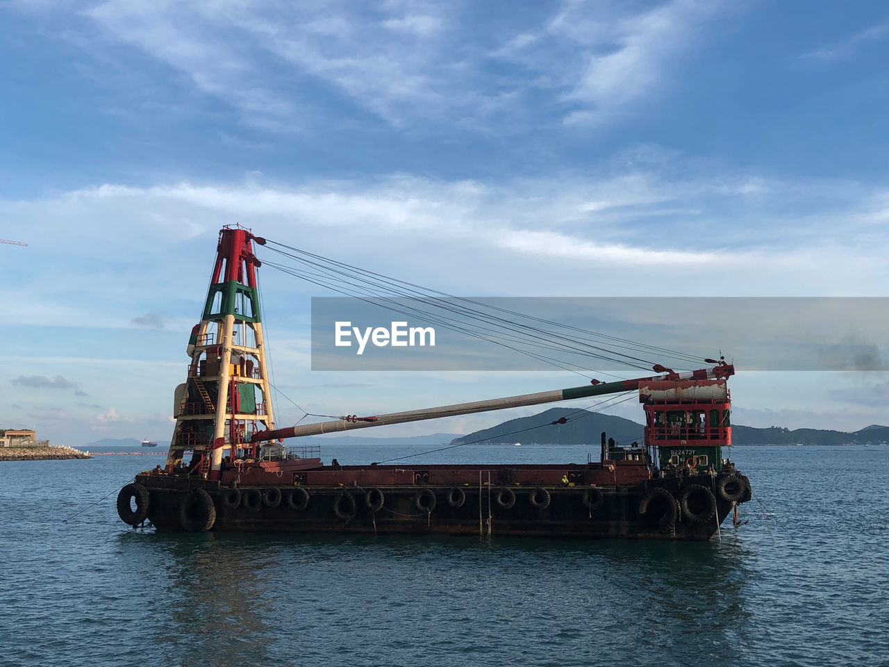 CRANES AT COMMERCIAL DOCK AGAINST SKY