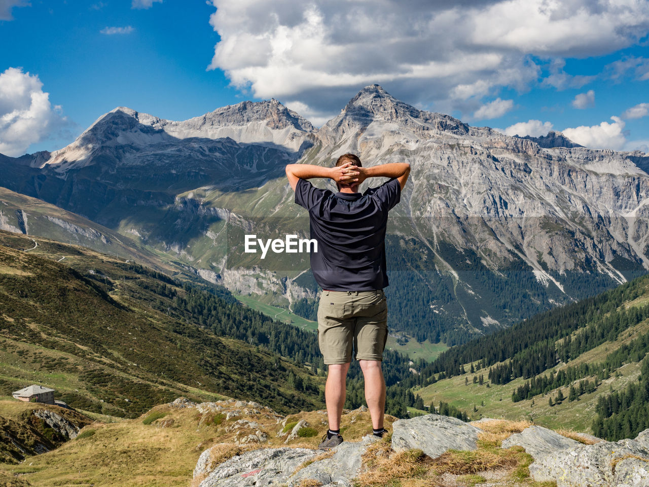 Full length of man standing on mountain against sky