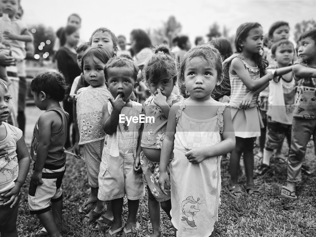 GROUP OF PEOPLE STANDING ON FIELD