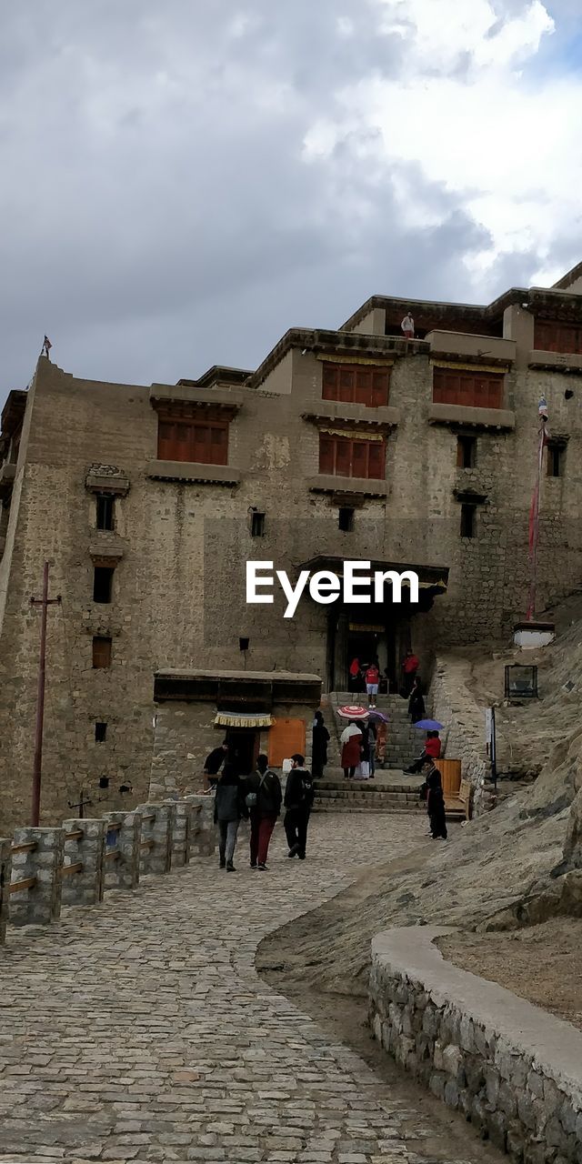 PEOPLE ON STREET AMIDST BUILDINGS IN CITY