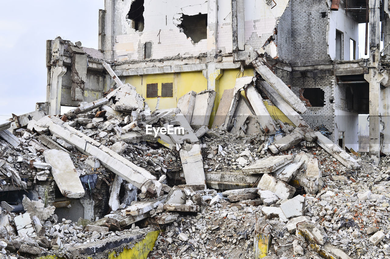 DAMAGED BUILDING AGAINST BROKEN WALL