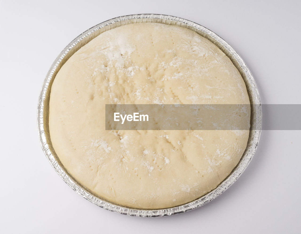 Directly above shot of dough in container against white background