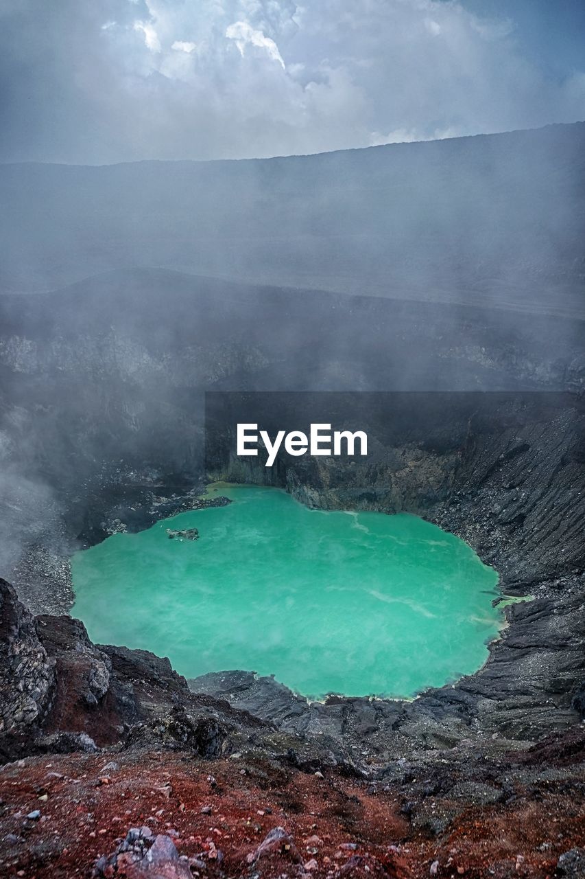 Blue crater lake of the santa ana volcano with clouds