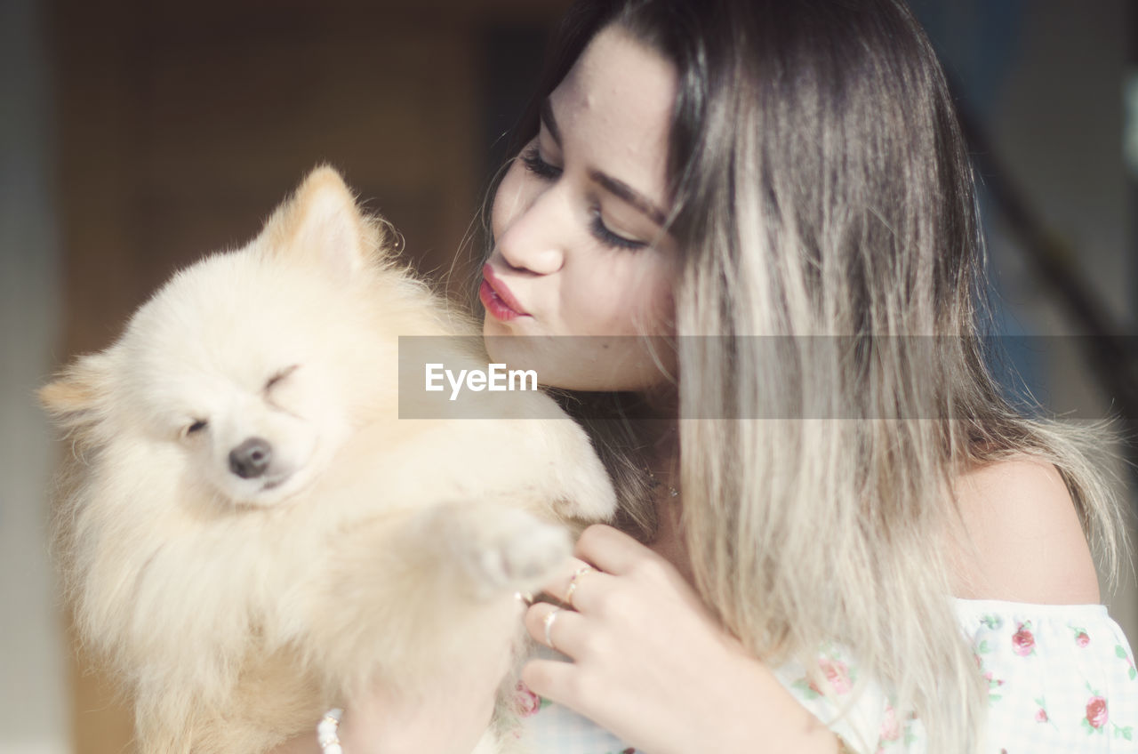 Beautiful woman with dog at home