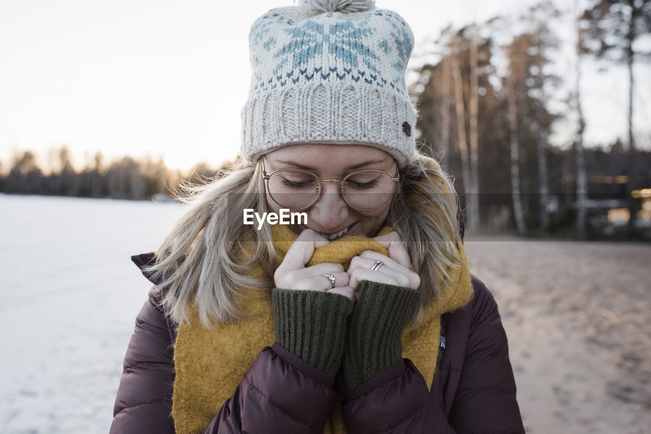 Portrait of a woman wrapped up warm whilst at the beach in sweden