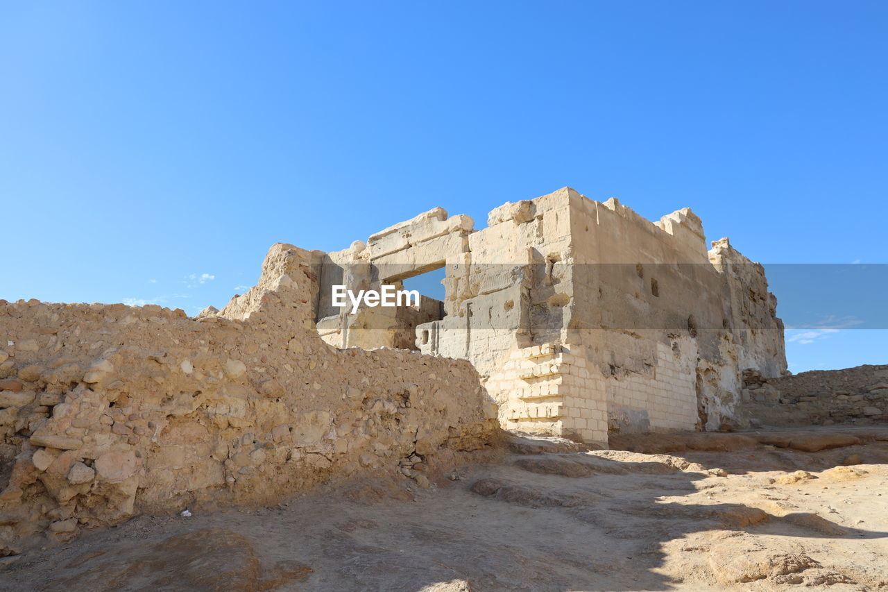 Low angle view of temple against clear blue sky