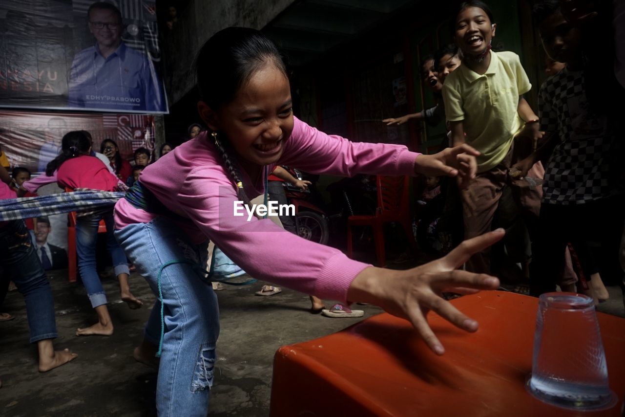 GROUP OF PEOPLE PLAYING IN ROOM