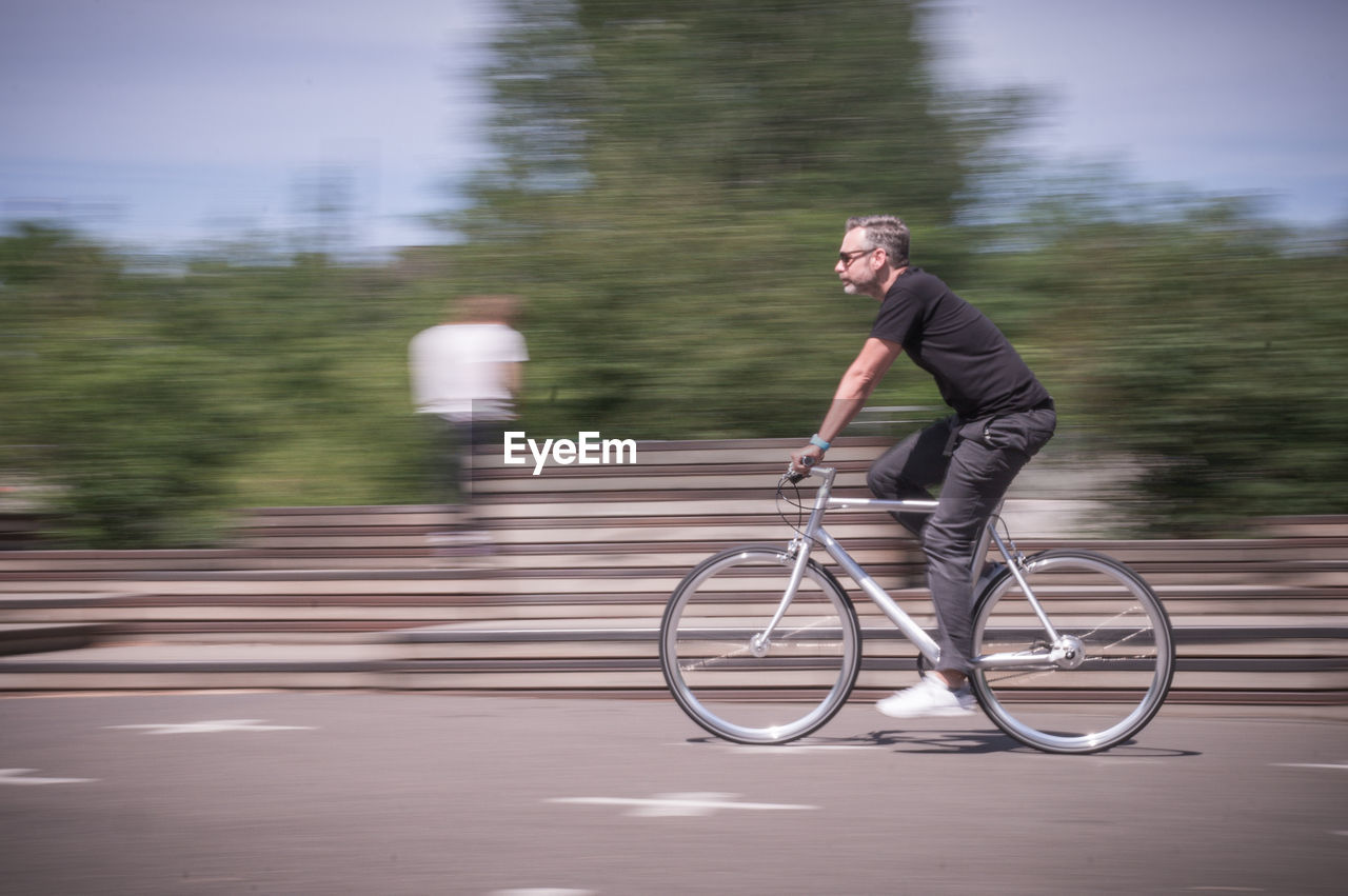 Man riding bicycle on road