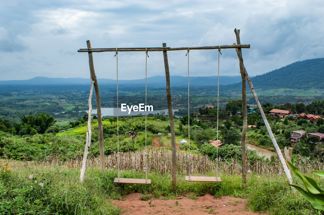 Swings hanging against landscape