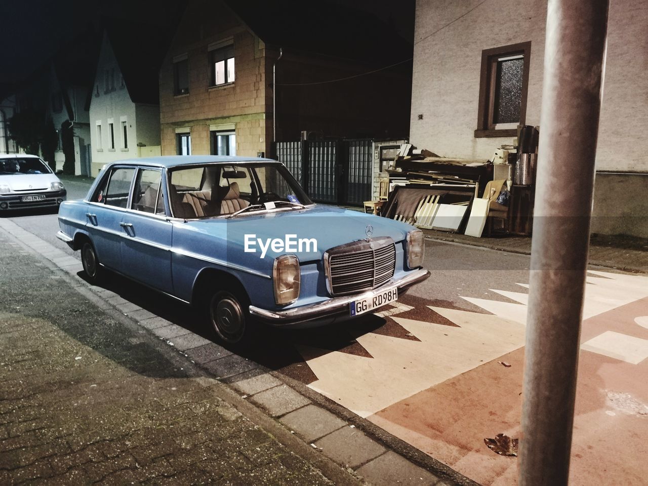 CAR PARKED ON STREET BY BUILDINGS