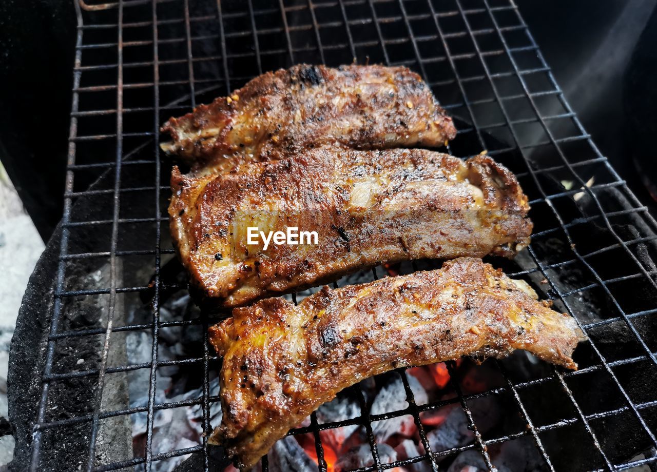 High angle view of meat on barbecue grill