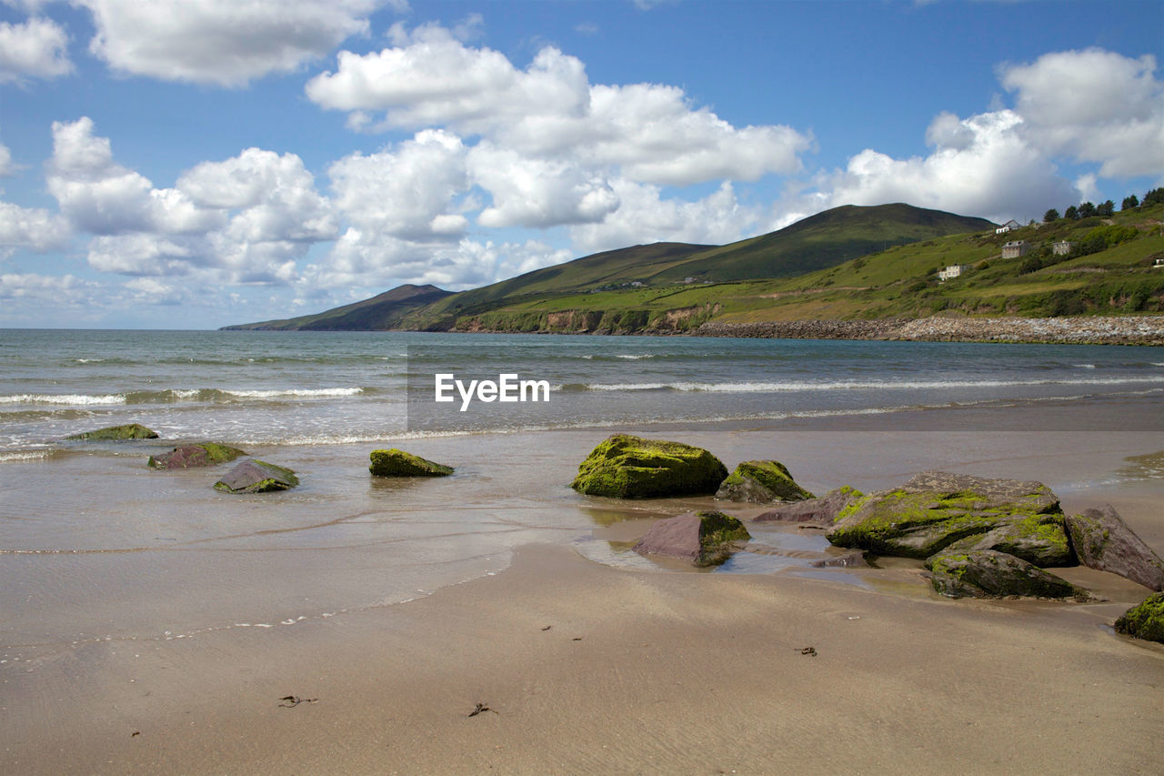 Scenic view of sea and mountains against sky