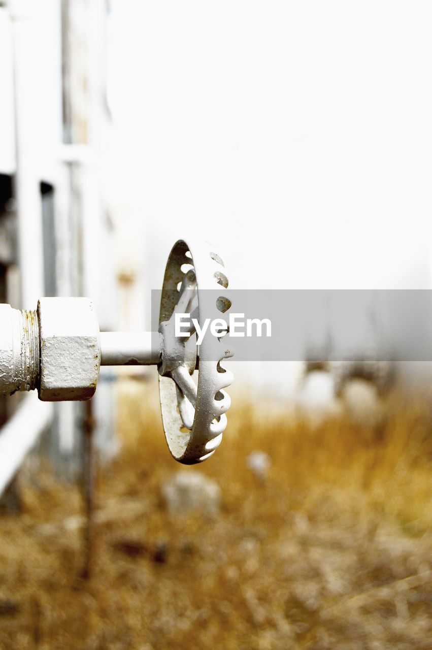 Close-up of fuel storage tank knob on field