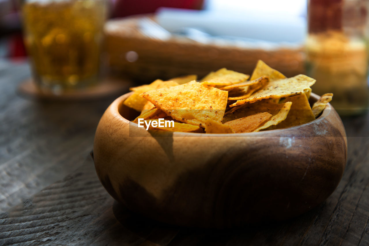 Close-up of nacho chips in bowl on table