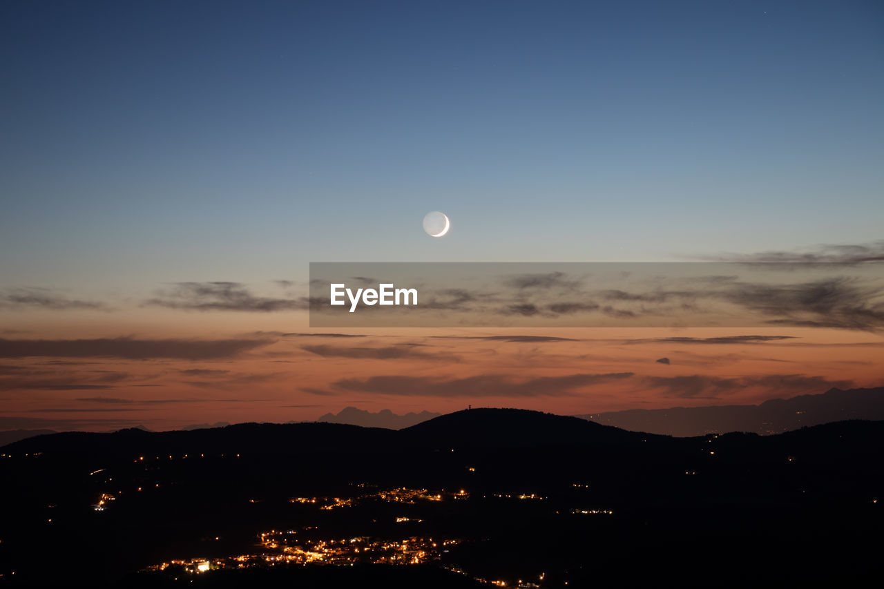 Scenic view of silhouette mountains against sky at night