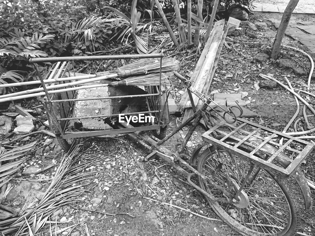 High angle view of abandoned bicycle and brooms in junkyard