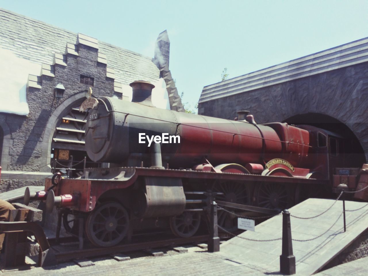 LOW ANGLE VIEW OF TRAIN ON INDUSTRY AGAINST CLEAR SKY