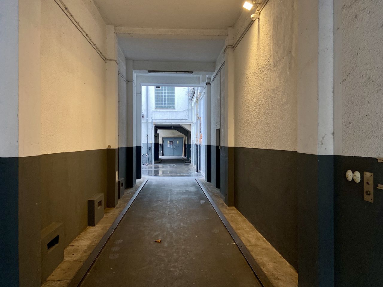 EMPTY CORRIDOR ALONG BUILDINGS