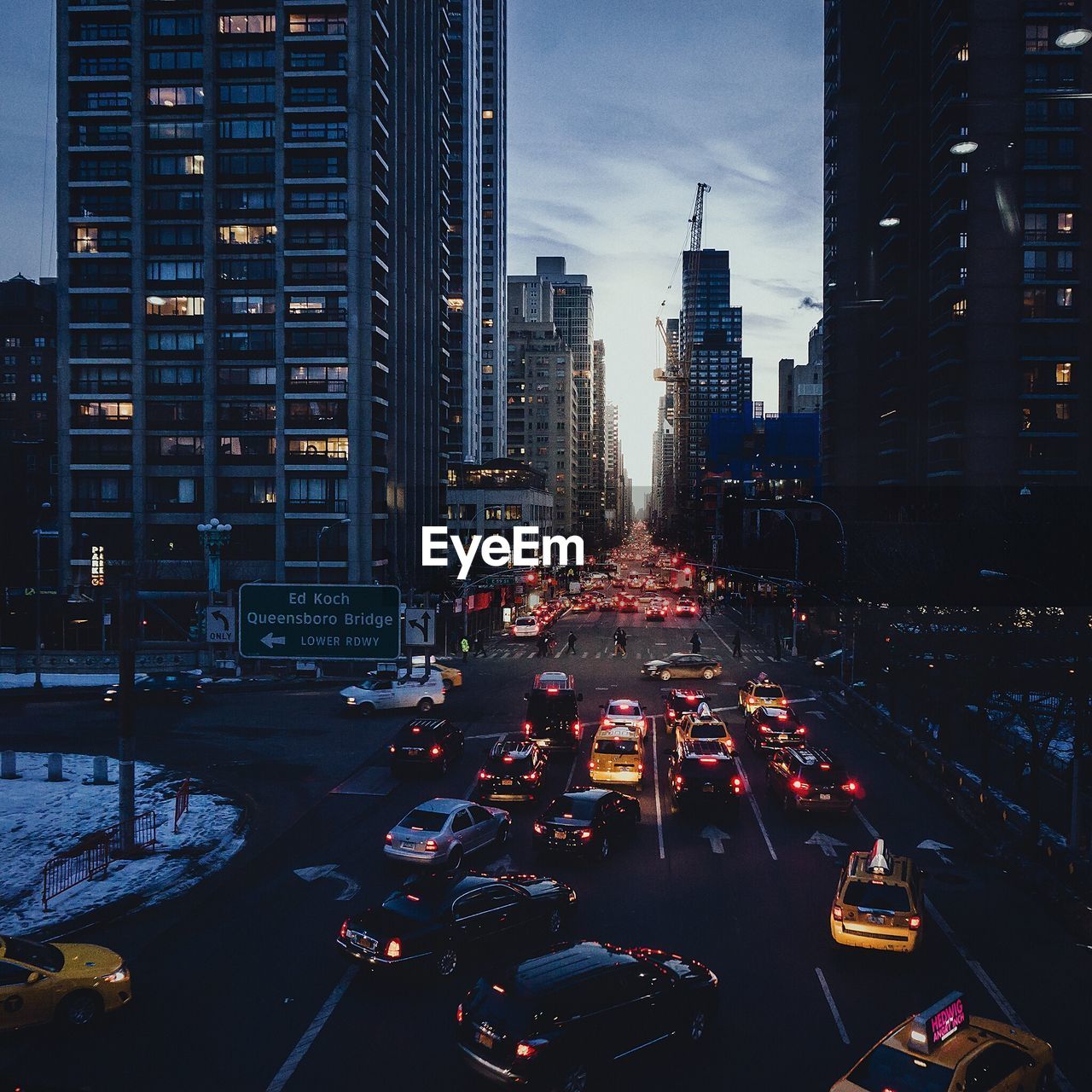 High angle view of cars on street amidst buildings in city