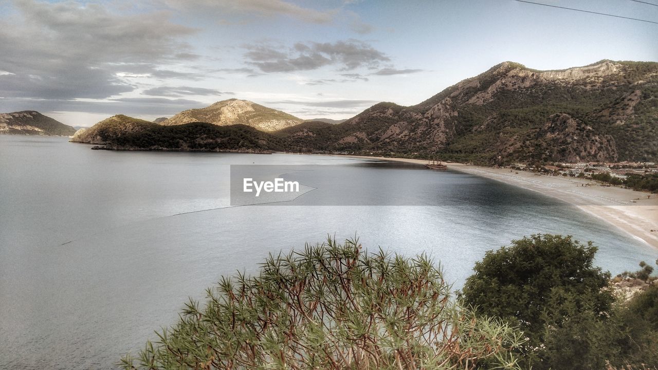 Scenic view of lake and mountains against sky