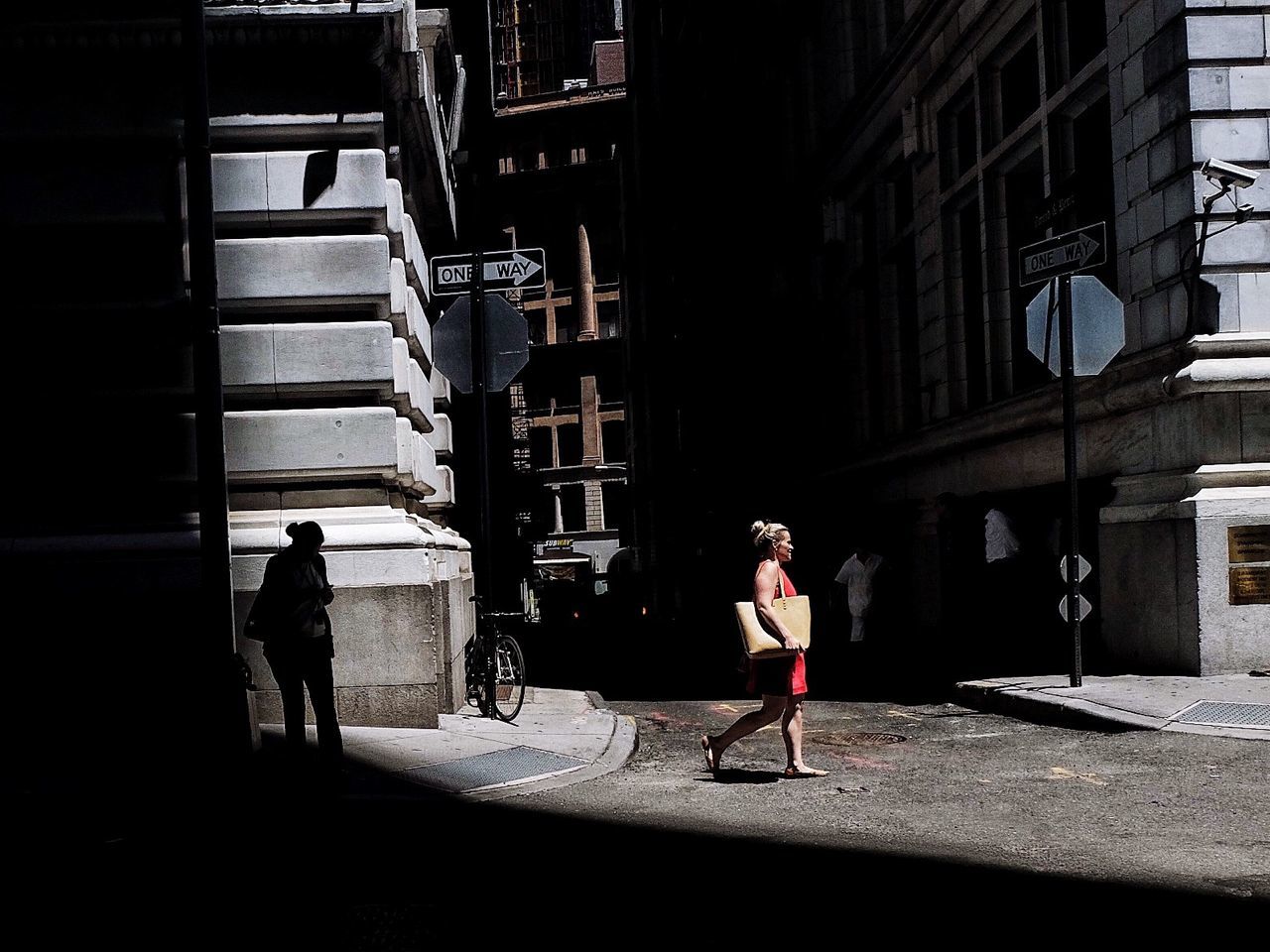 WOMAN WALKING ON CITY STREET