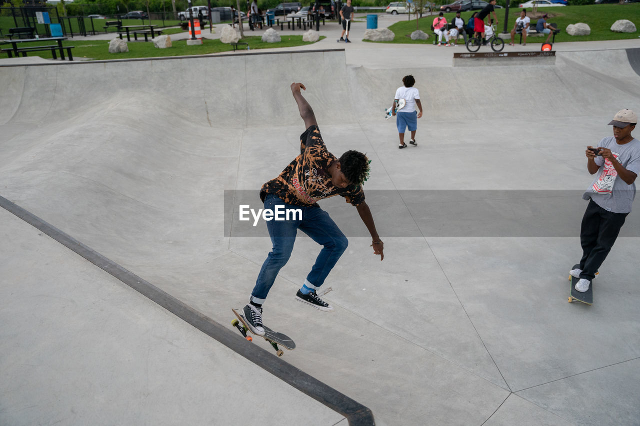 FULL LENGTH OF PEOPLE ON SKATEBOARD