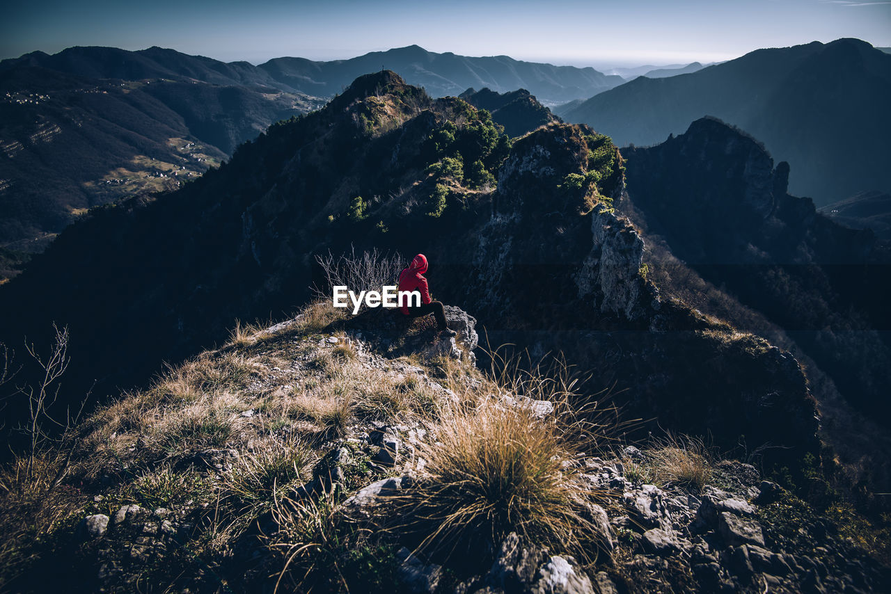 High angle view of man sitting on mountain