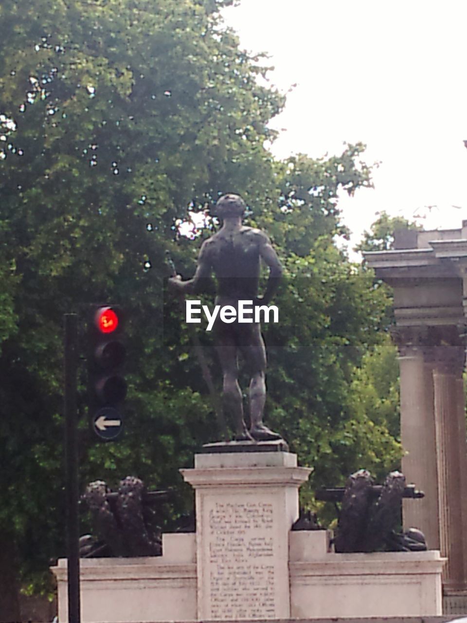 LOW ANGLE VIEW OF STATUE AGAINST TREES