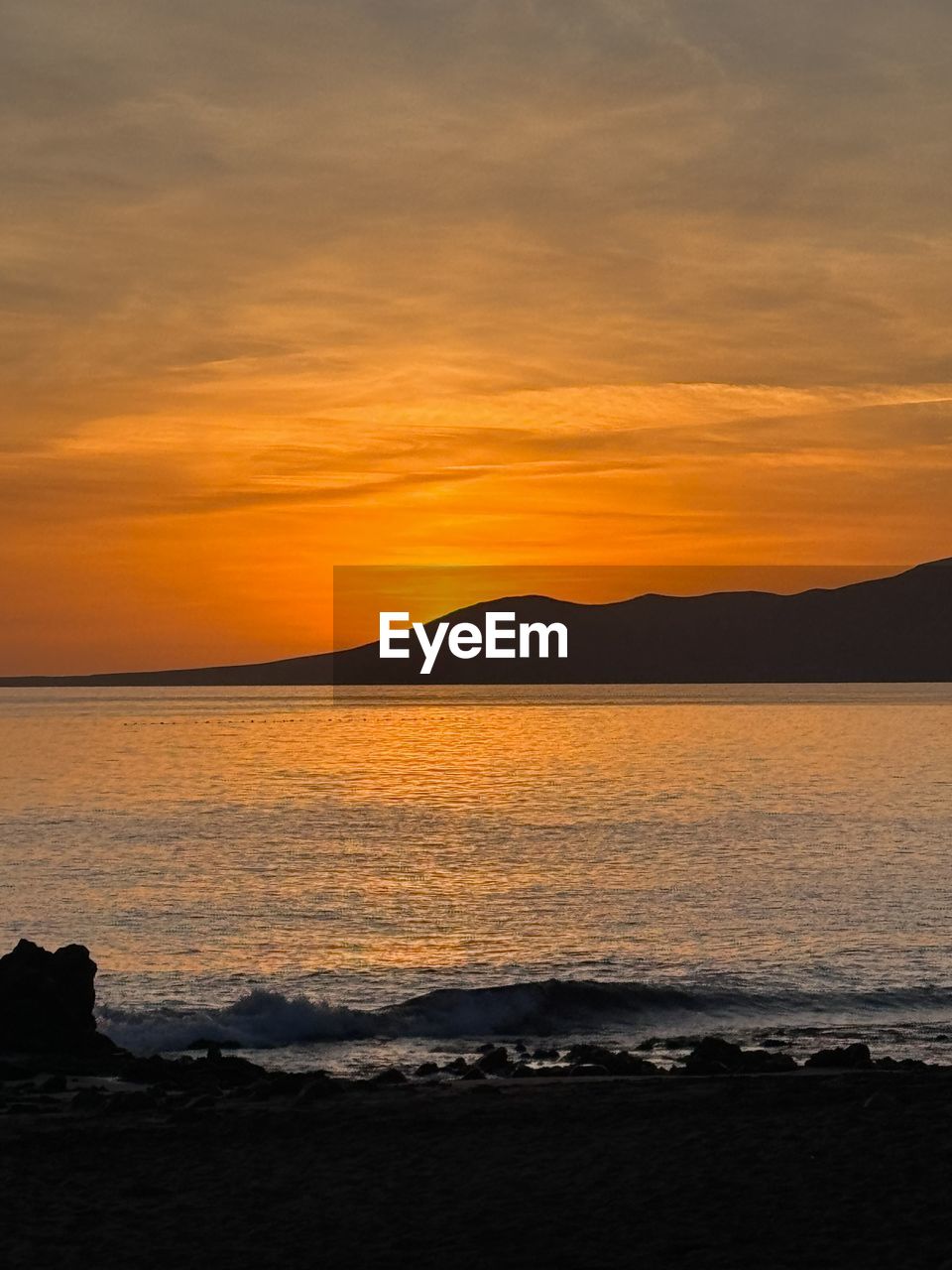 scenic view of beach against sky during sunset