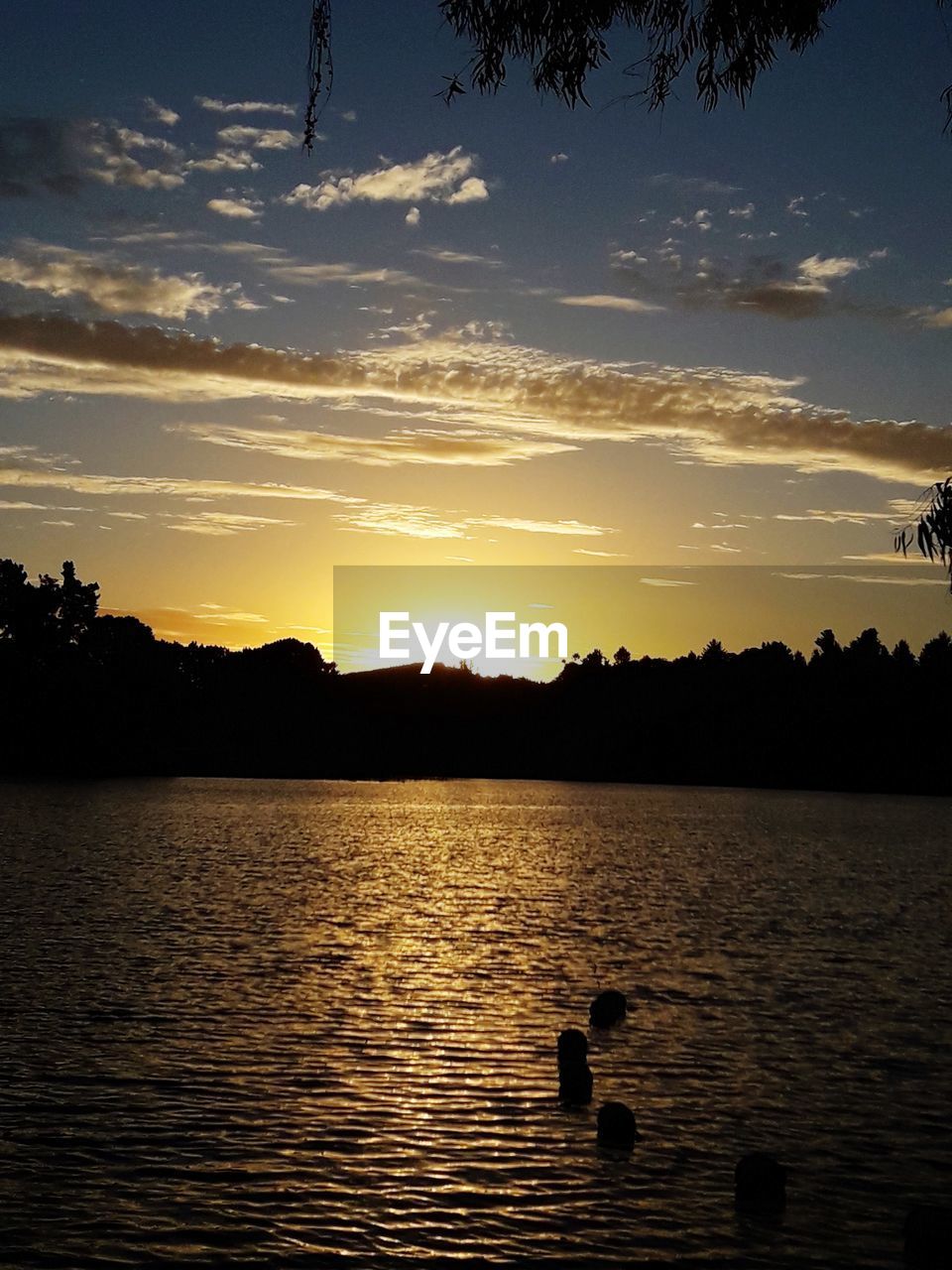 SCENIC VIEW OF LAKE AGAINST ORANGE SKY