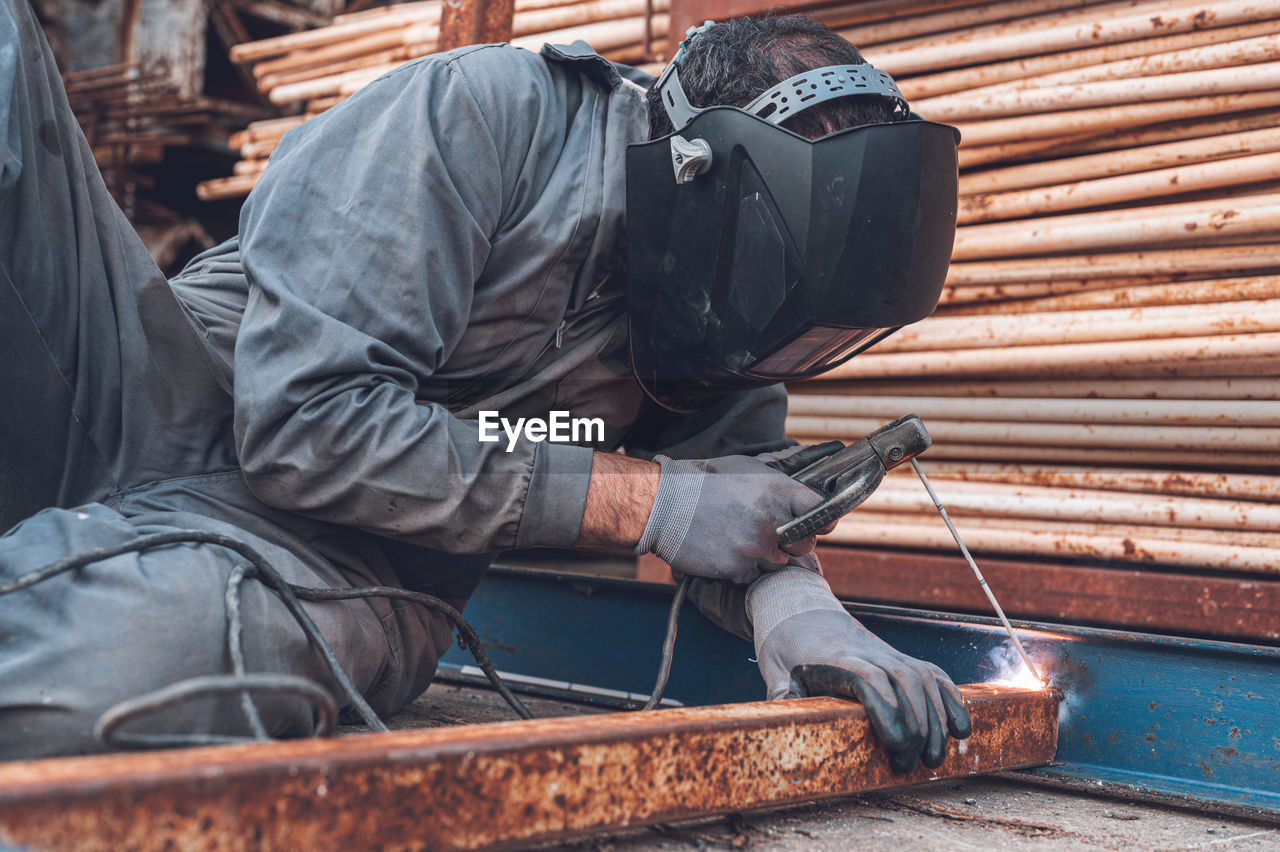 MAN WORKING ON WOOD