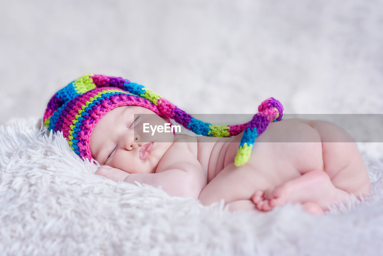 CLOSE-UP OF BABY SLEEPING IN BED