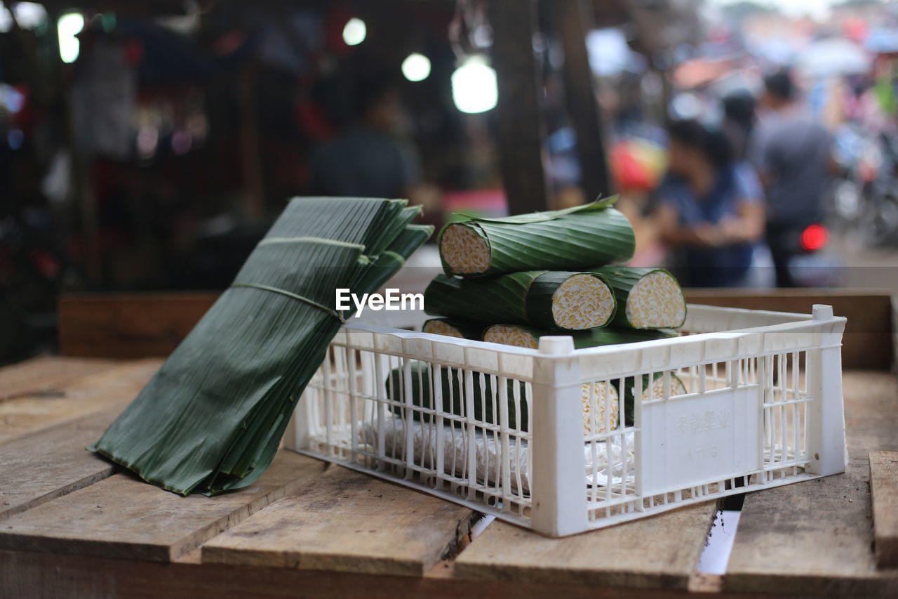 Close-up of food wrapped in banana leaves on wooden table