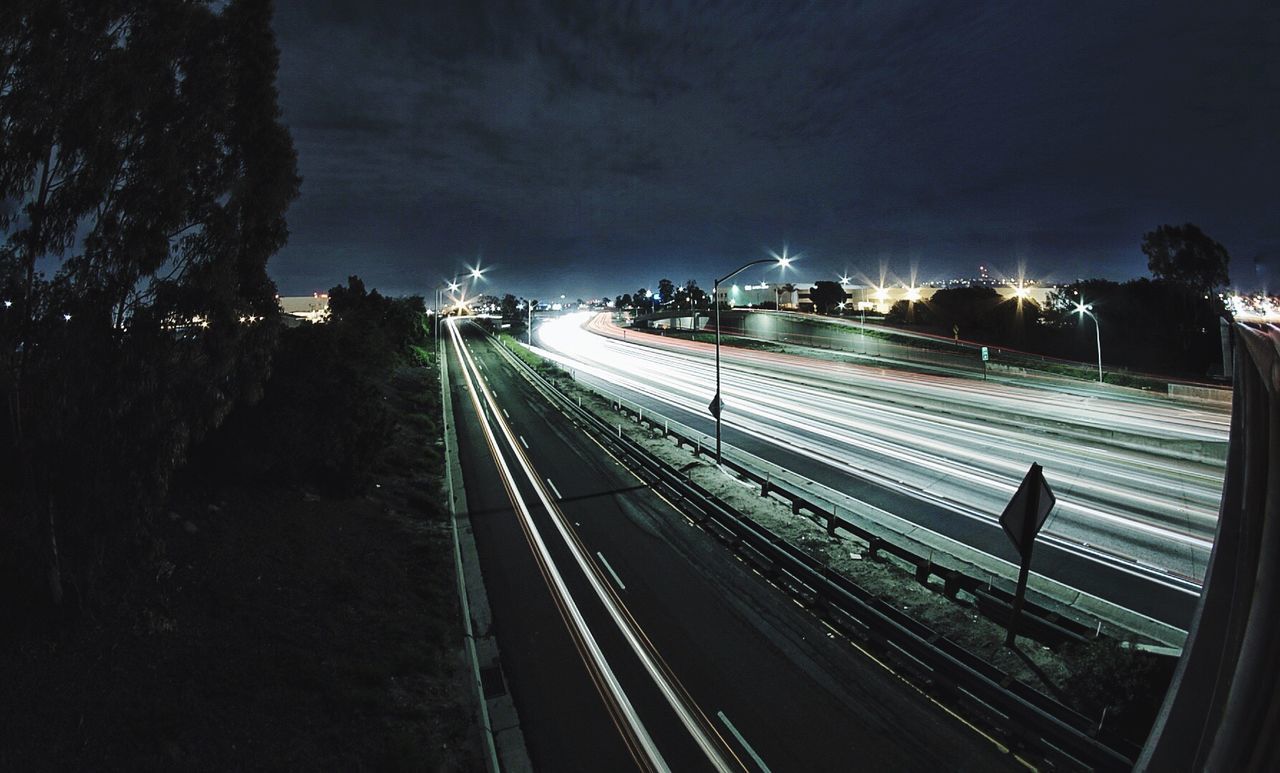 High angle view of light trails on railroad track at night