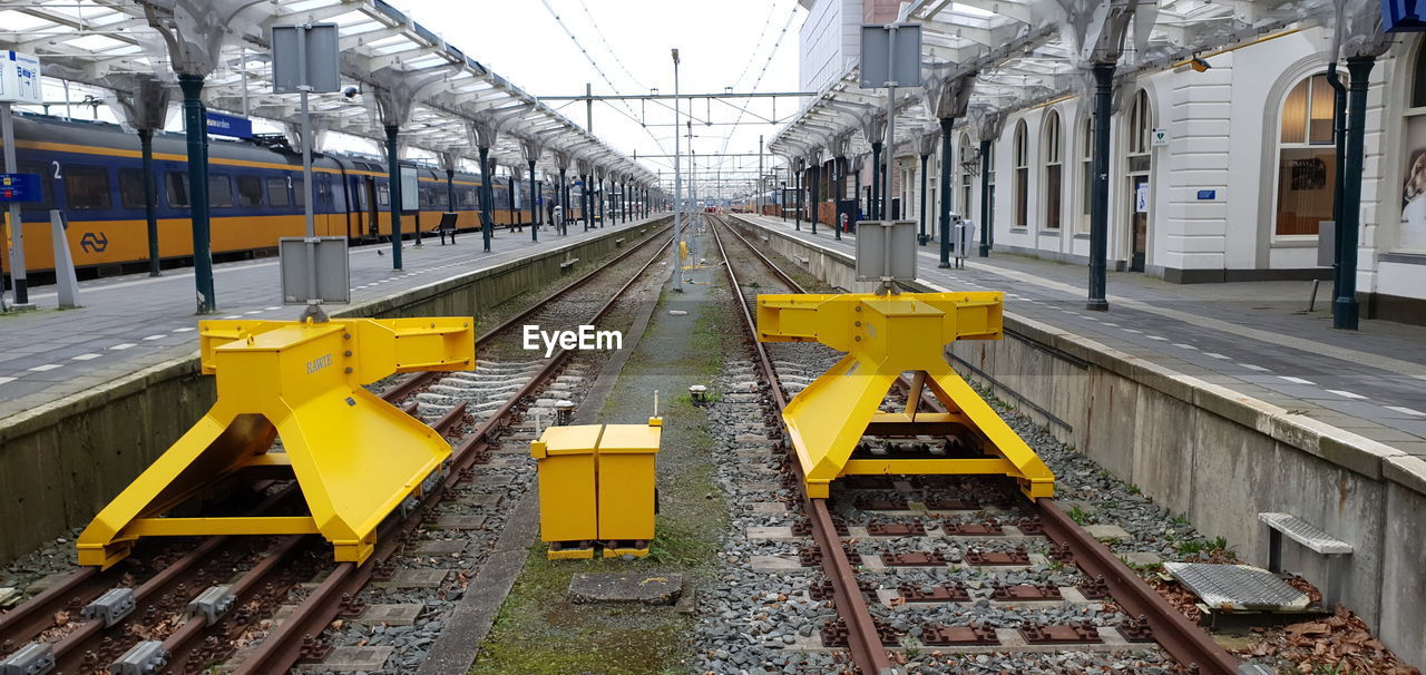 Yellow train on railroad tracks