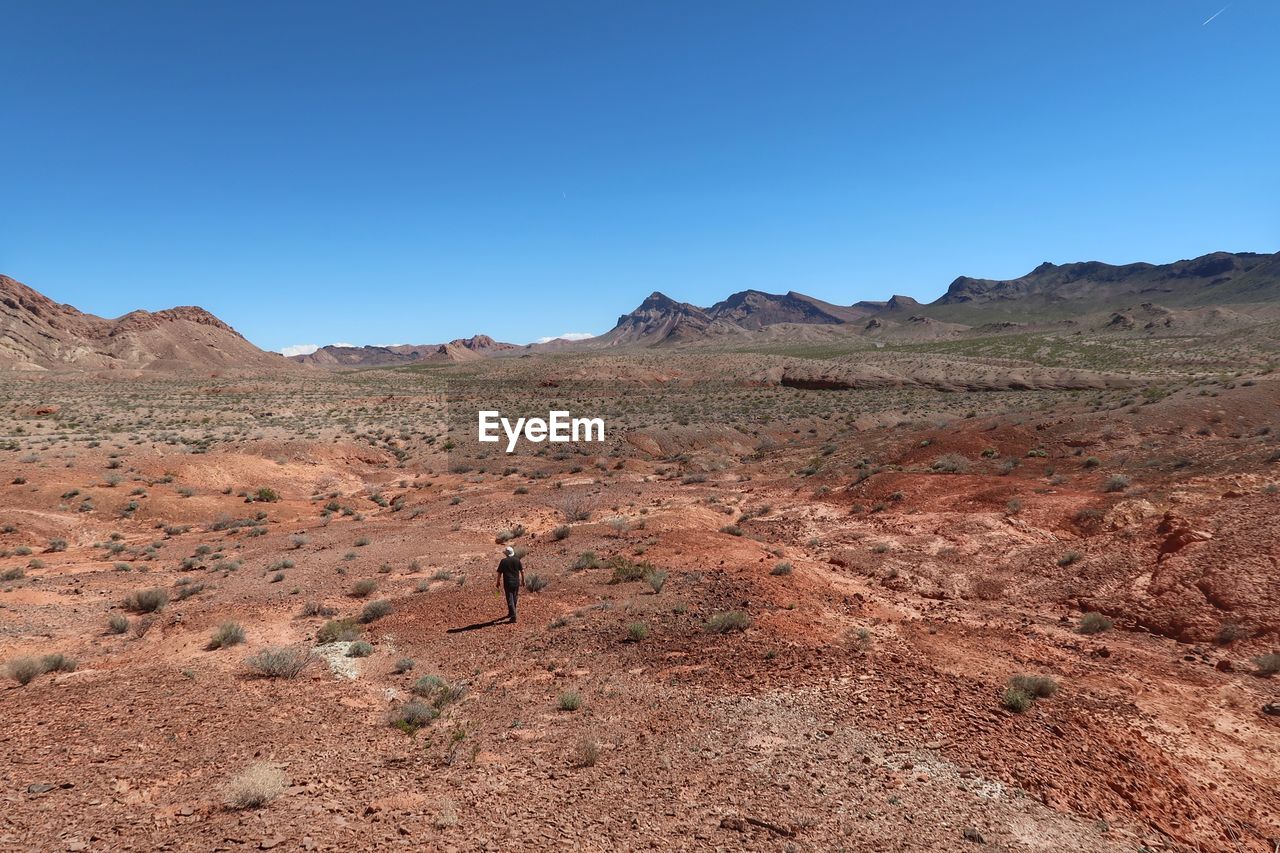 Scenic view of desert against blue sky