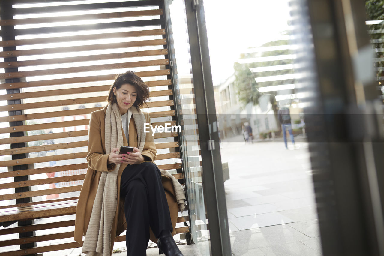 Smiling businesswoman using cell phone