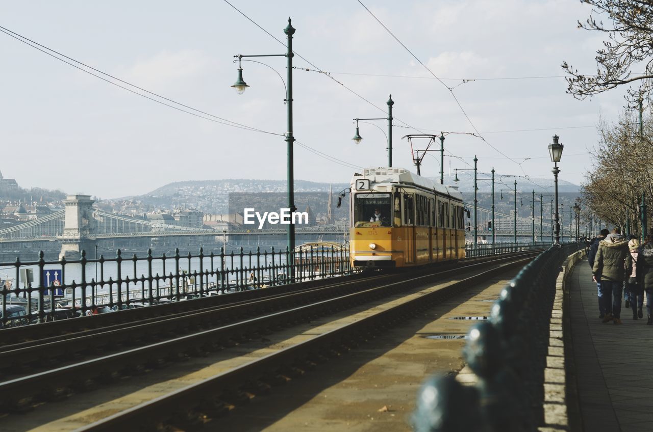 Tram at railroad station platform against sky