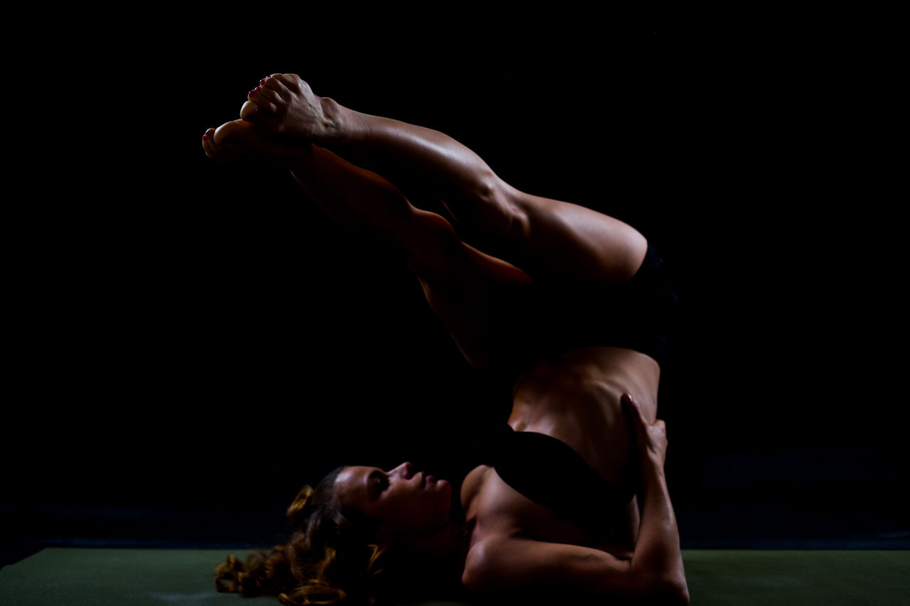 Midsection of woman against black background