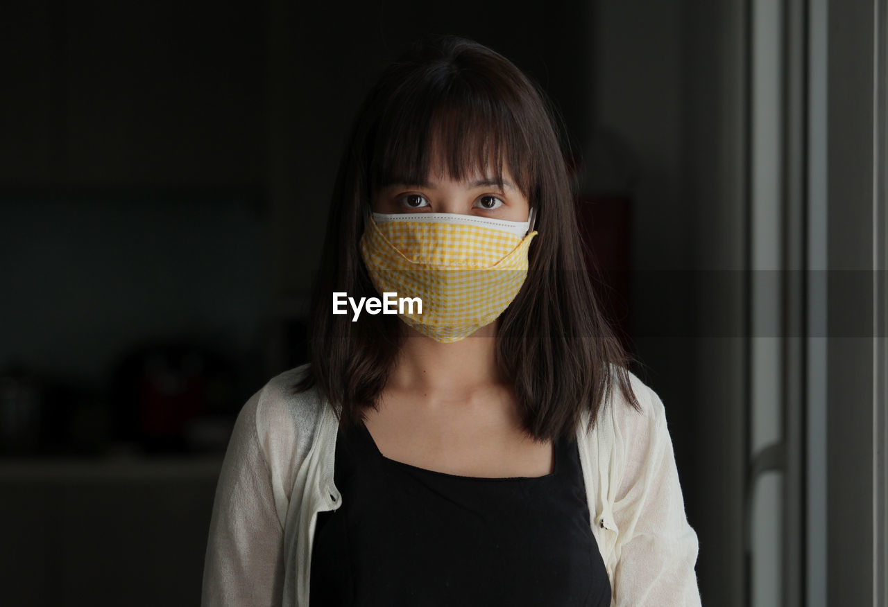 Portrait of an attractive healthy girl, wearing a reusable cotton mask