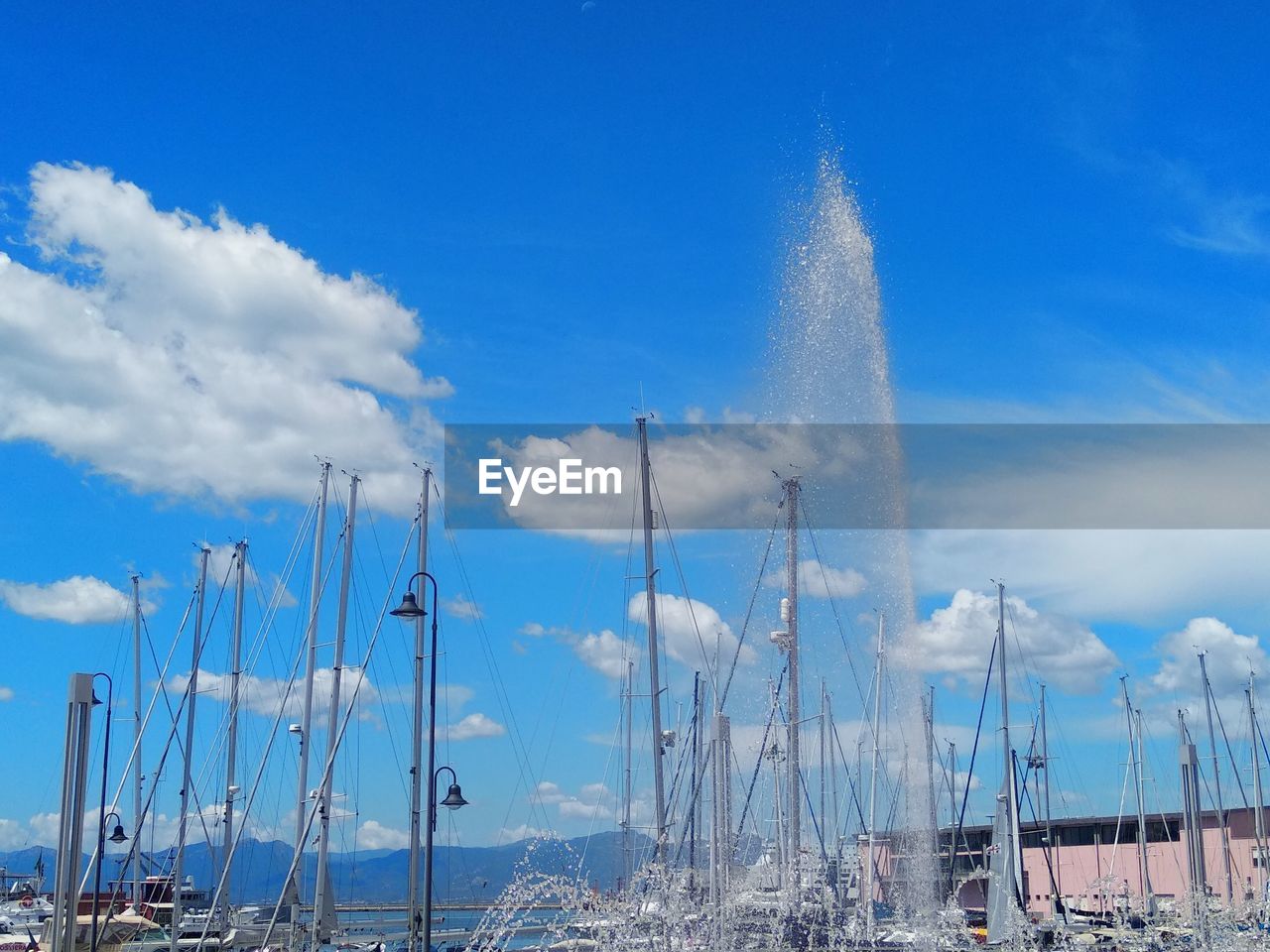 Panoramic view of sailboats and fountain against sky 