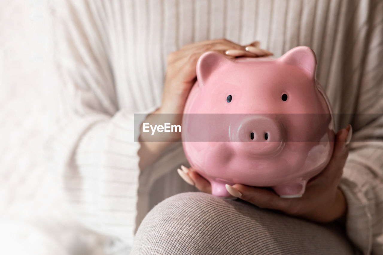 High angle view of piggy bank on bed at home