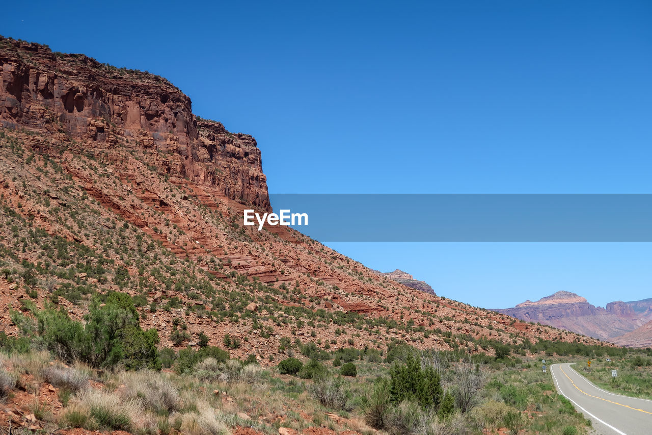 Scenic view of mountains against clear blue sky