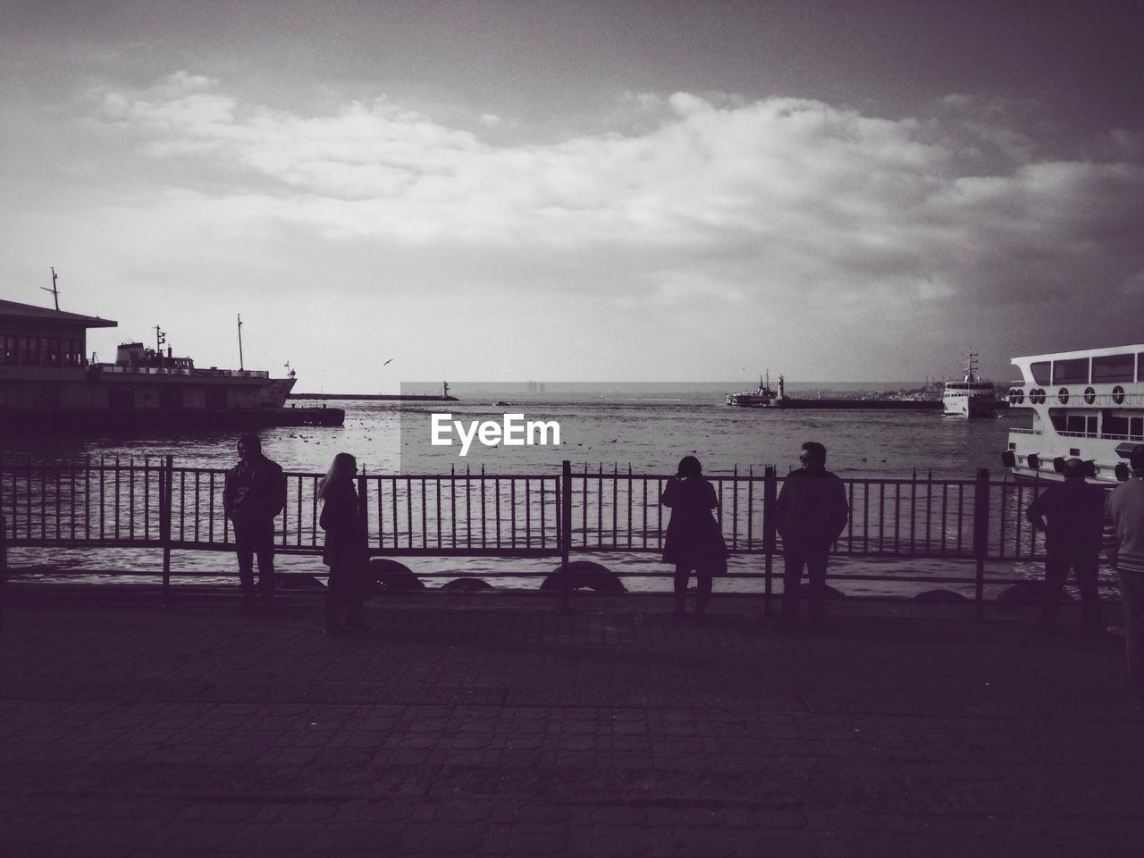 People standing on promenade against sea