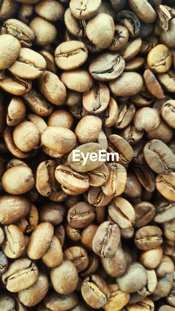 FULL FRAME SHOT OF COFFEE BEANS IN BACKGROUND